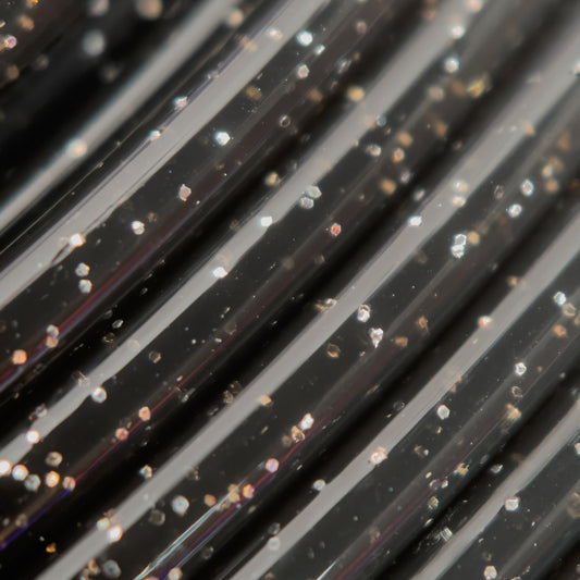 Cookiecad Black Star Stuff PLA filament close-up – silver glitter in black base