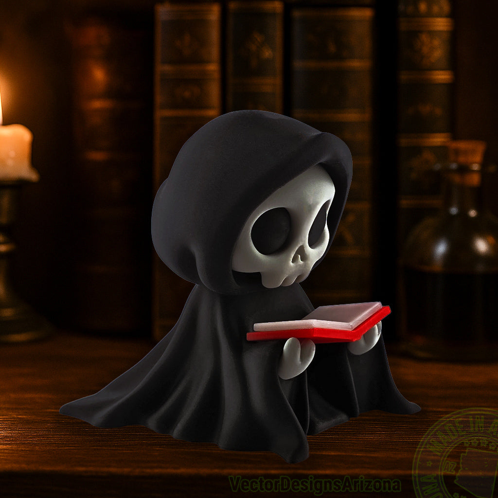 Small hooded grim reaper figurine reading a red book on wooden shelf.