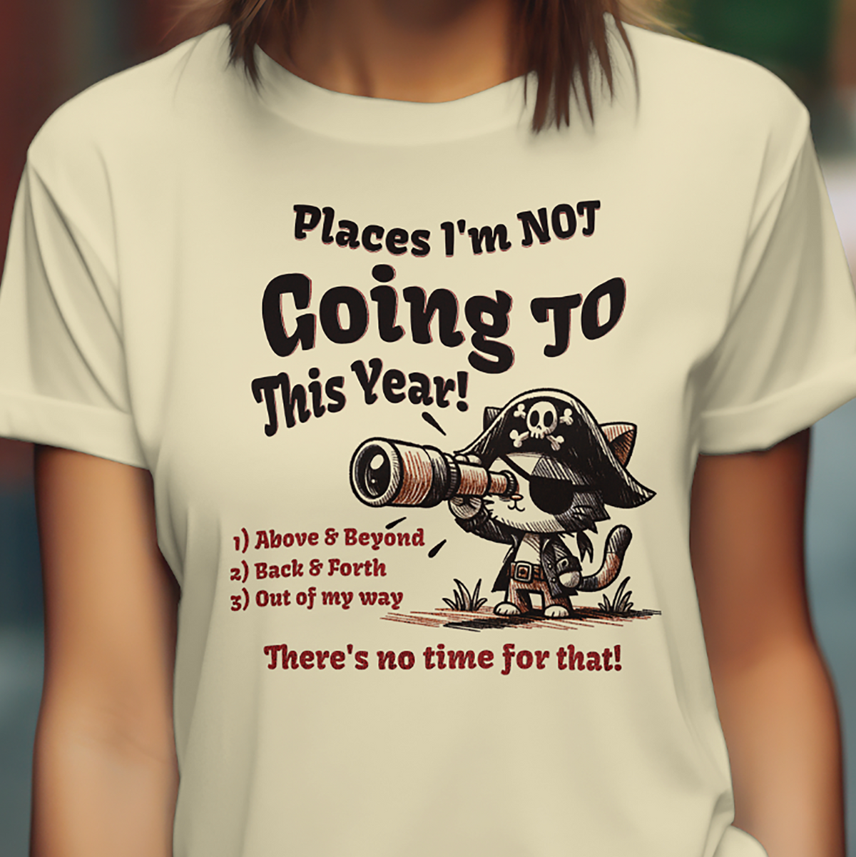 Close-up of pirate cat humor text graphic on cream unisex T-shirt.