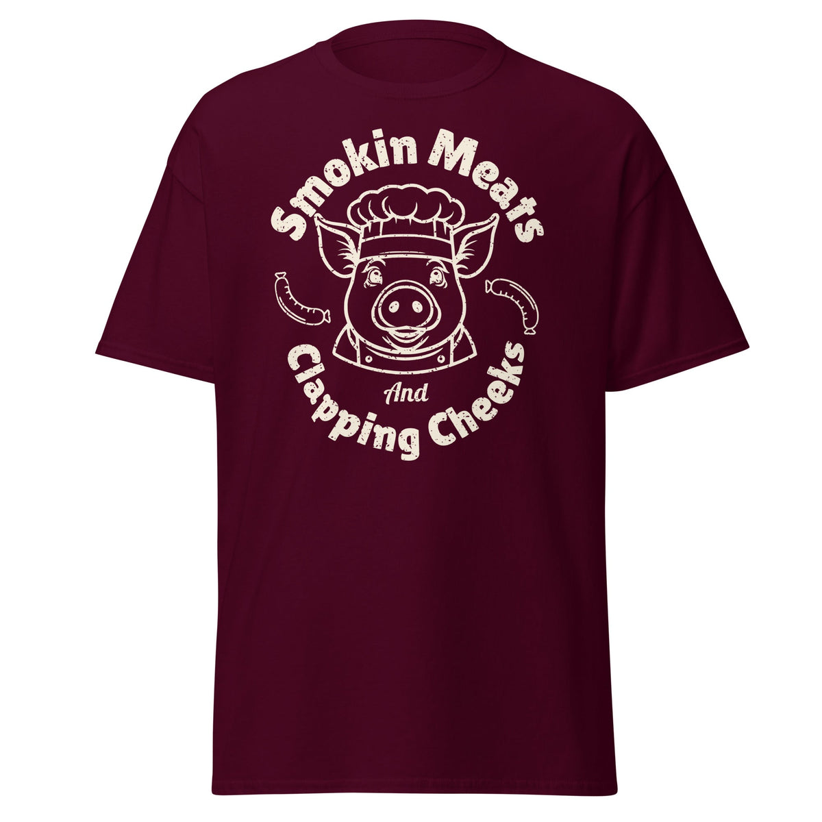 Maroon Smokin Meats pig chef barbecue T-shirt on plain white background.