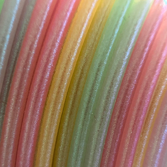 Cookiecad Pastel Rainbow Elixir PLA filament close-up – rainbow gradient with iridescent shimmer