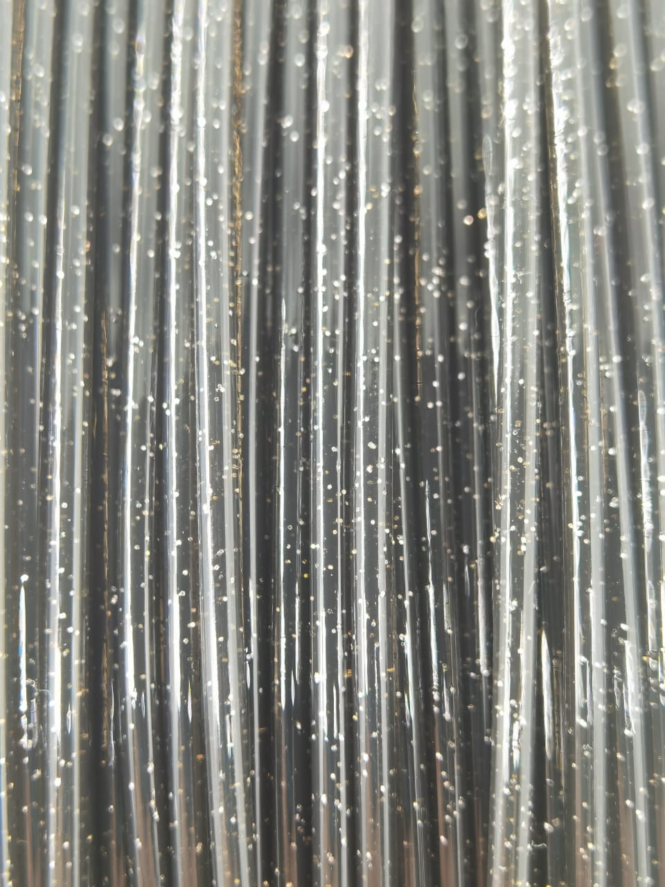 Cookiecad Black Star Stuff PLA filament detail – glitter sparkle on black surface
