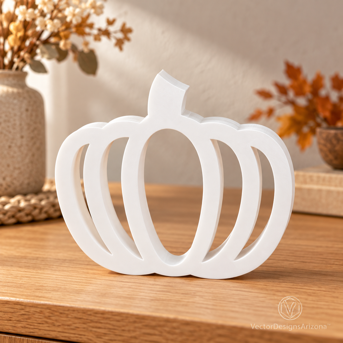 One ivory white minimalist 3D-printed pumpkin with an open-frame design, styled on a wood console with warm fall decor.
