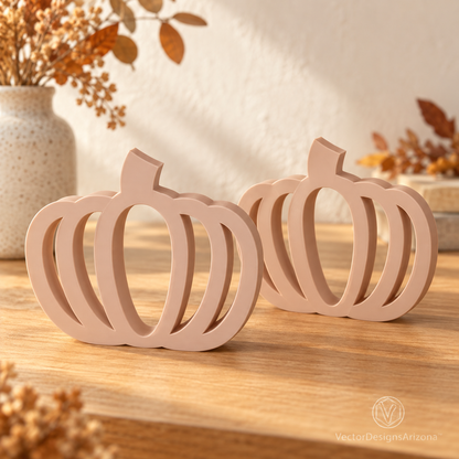 Two beige latte-brown minimalist 3D-printed pumpkins with open-frame designs, styled on a warm autumn console.