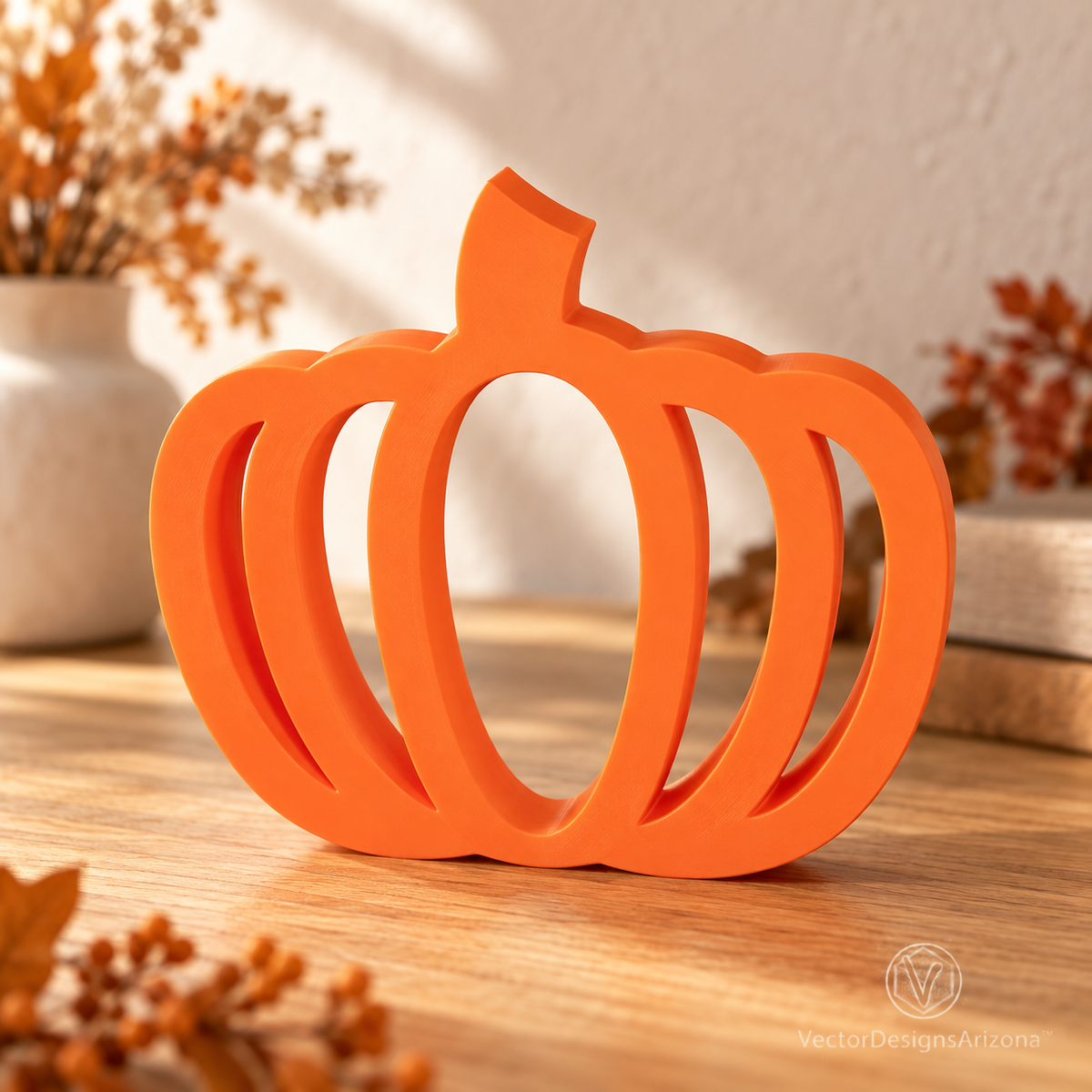 One Mandarin orange minimalist 3D-printed pumpkin with an open-frame design, styled on a wood console with warm fall decor.