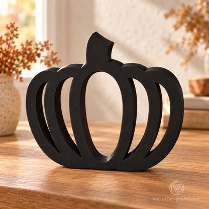 One matte black minimalist 3D-printed pumpkin with an open-frame design, styled on a wood console with warm fall decor.