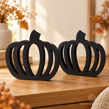 Two matte black minimalist 3D-printed pumpkins with open-frame designs, styled on a wood console with warm fall decor.