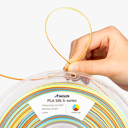 AMOLEN S-Series Silk PLA lifestyle and packaging shot showing vacuum-sealed spool with moisture protection detail