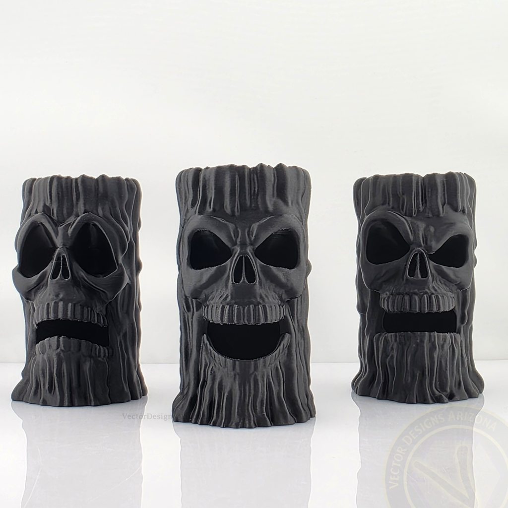 Three Black 3D printed skull candle holders by VectorDesignsArizona with LED lights placed inside the base, lighting up the eyes and mouth for dramatic haunted house decor.
