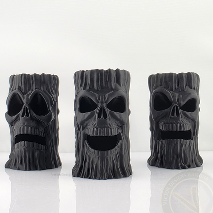 Three Black 3D printed skull candle holders by VectorDesignsArizona with LED lights placed inside the base, lighting up the eyes and mouth for dramatic haunted house decor.
