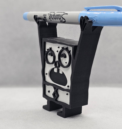 Side view of 3D printed Doodle Bob pencil holder with wide cartoon face design holding a blue marker
