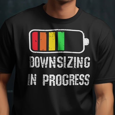 Downsizing in Progress T-shirt with battery graphic on black Gildan 5000 tee by VectorDesignsArizona.