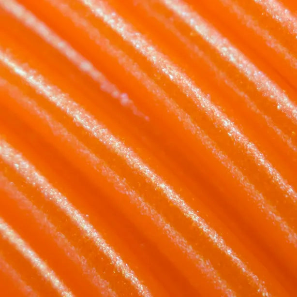 Cookiecad Orange Elixir PLA filament close-up – iridescent shimmer on orange base