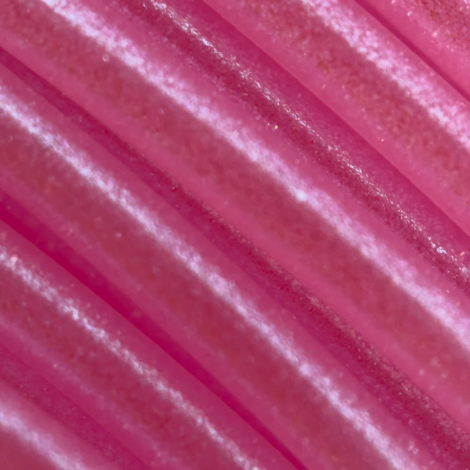 Cookiecad Bubblegum Elixir PLA filament close-up – iridescent shimmer on pink base