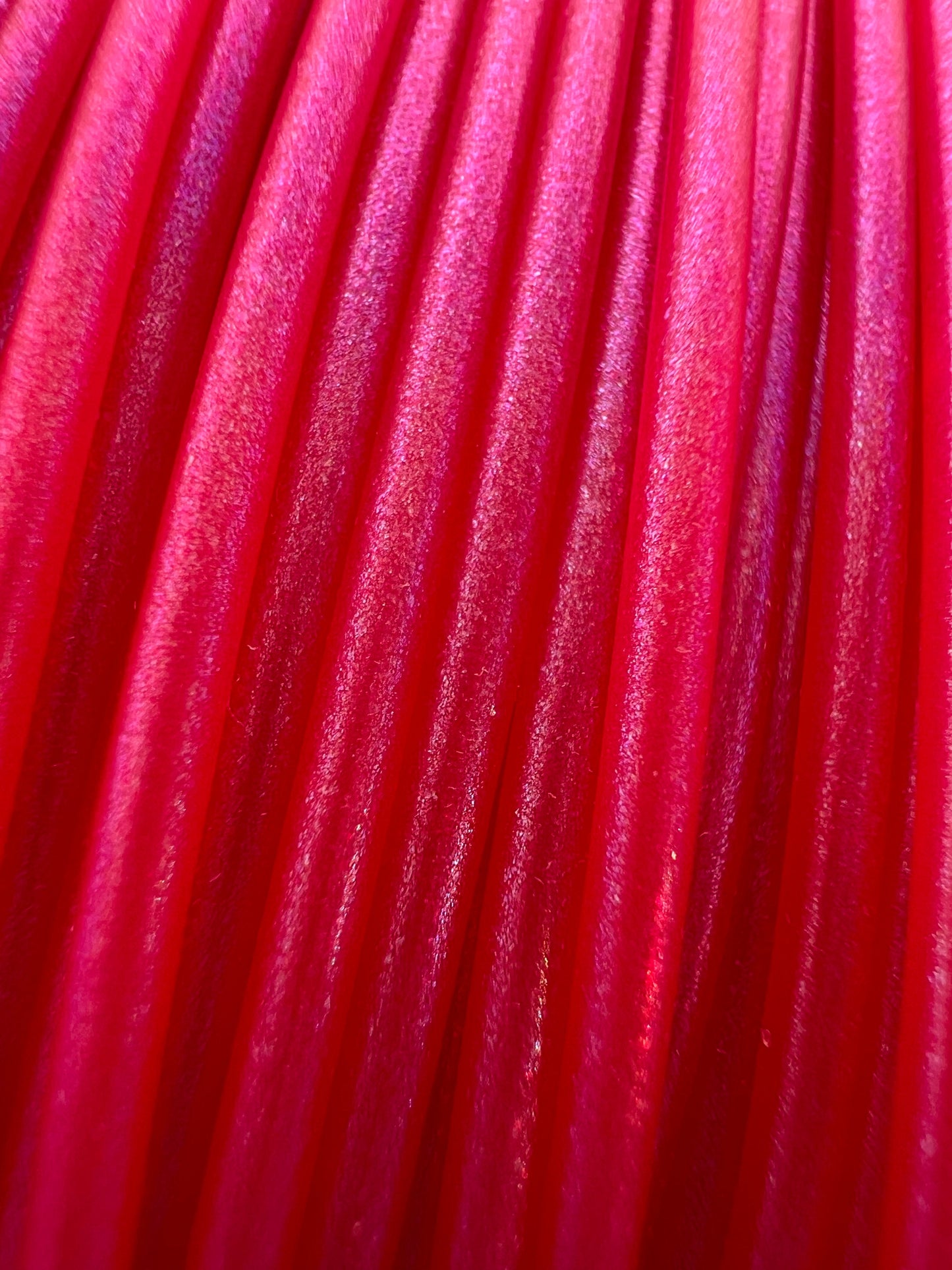 Cookiecad Magenta Elixir PLA filament close-up – iridescent shimmer on magenta base