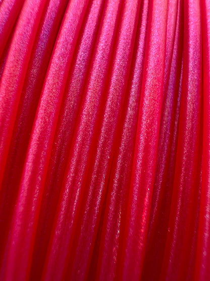 Cookiecad Magenta Elixir PLA filament close-up – iridescent shimmer on magenta base