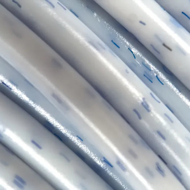 Cookiecad Vanilla Blueberry PLA filament close-up – blue-purple speckles in creamy white PLA base