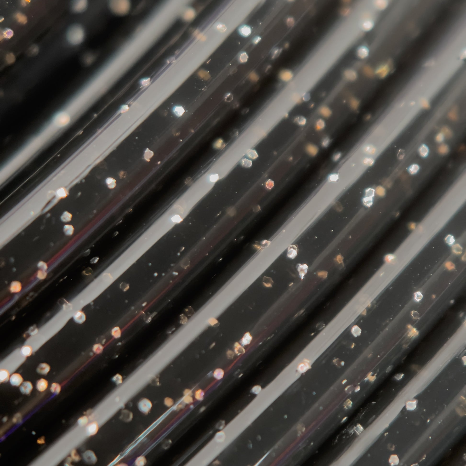 Cookiecad Black Star Stuff PLA filament close-up – silver glitter in black base