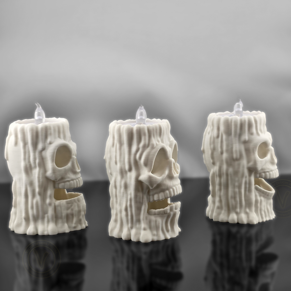 Side profile view of three VectorDesignsArizona 3D printed skull flameless candle holders, showing textured melted wax design and skull shape for gothic decor.