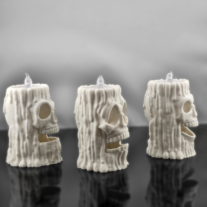 Side profile view of three VectorDesignsArizona 3D printed skull flameless candle holders, showing textured melted wax design and skull shape for gothic decor.