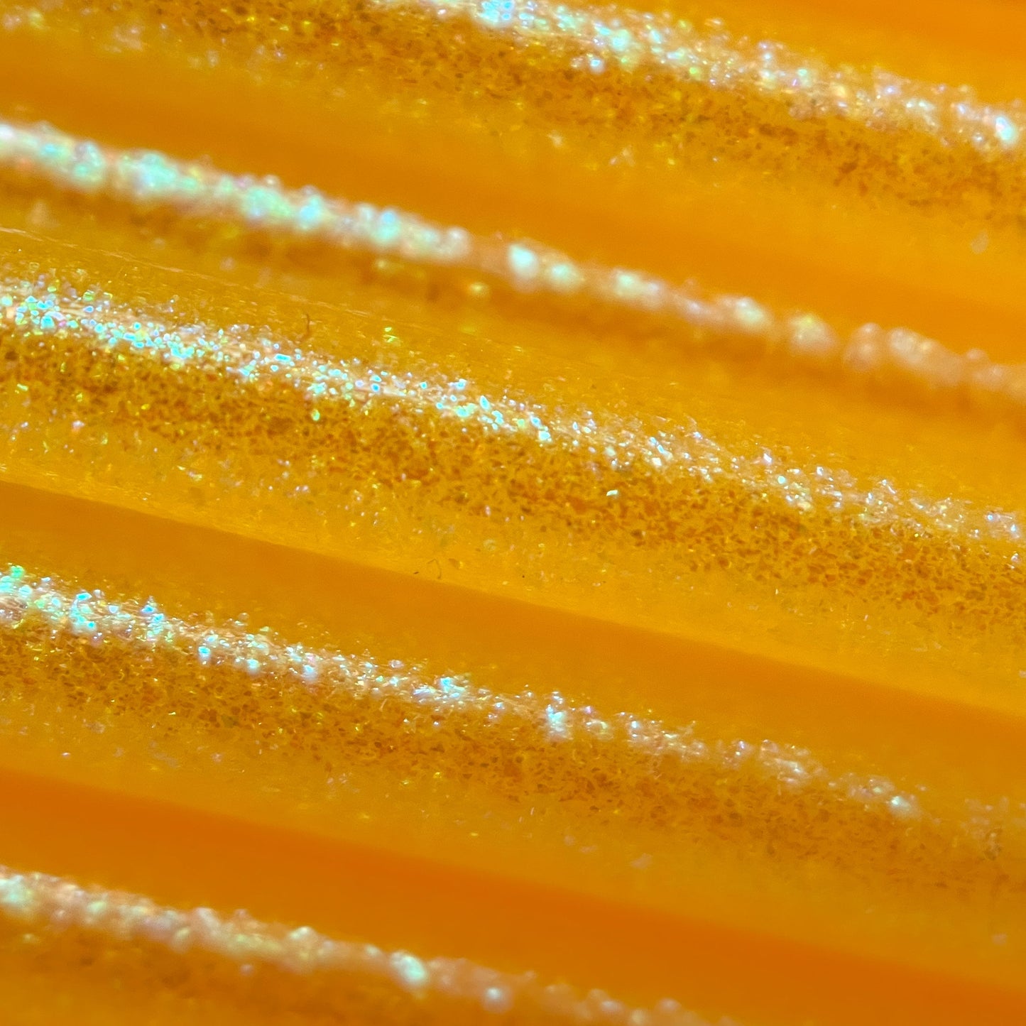 Cookiecad Solar Flare Elixir TPU filament close-up – iridescent green shimmer on yellow base