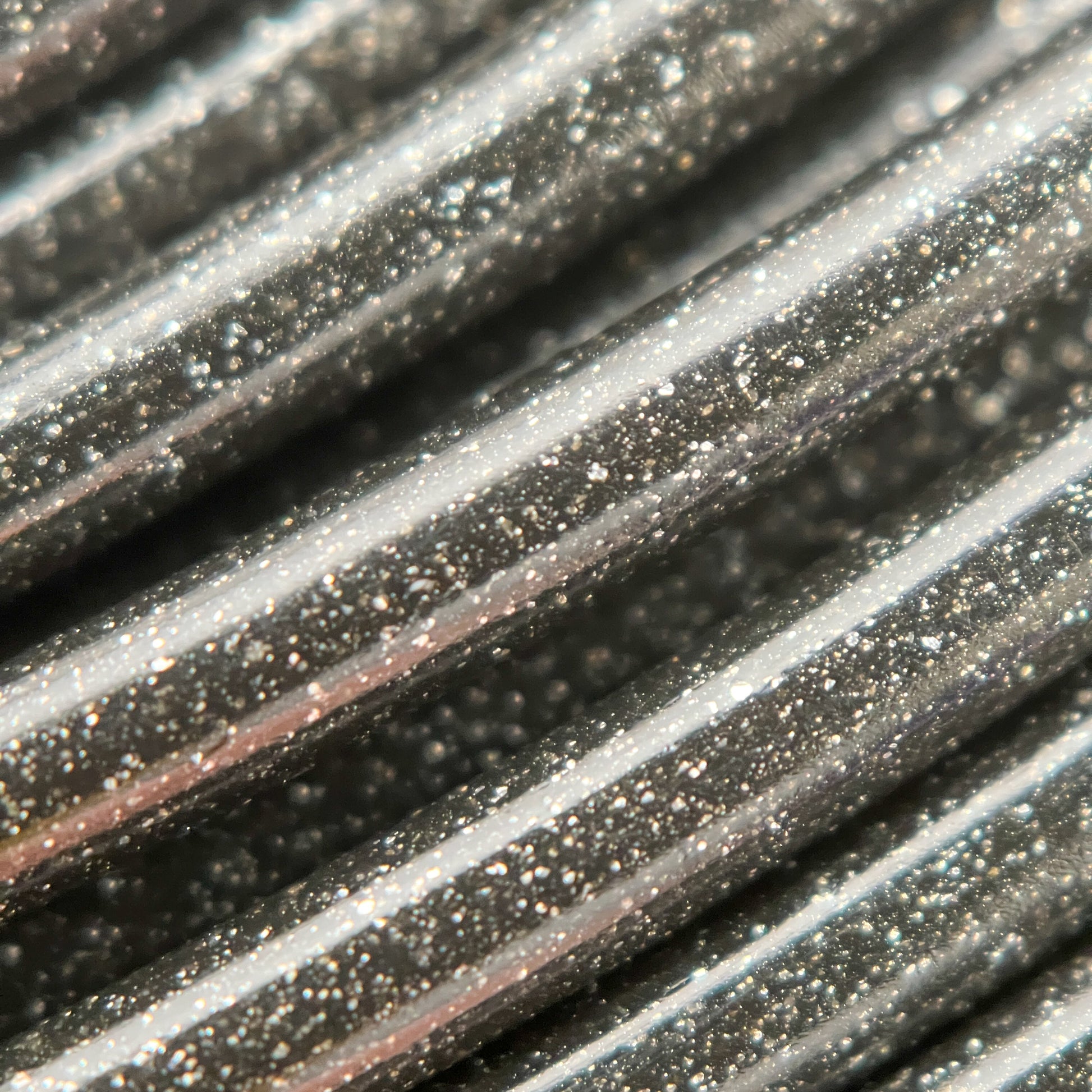 Cookiecad Star Dust Glitter Black PLA filament close-up – fine glitter in deep black base