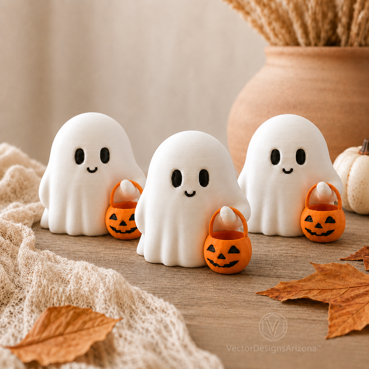 Three handmade white Trick-or-Treat Ghost figurines with orange pumpkin buckets in an autumn display.