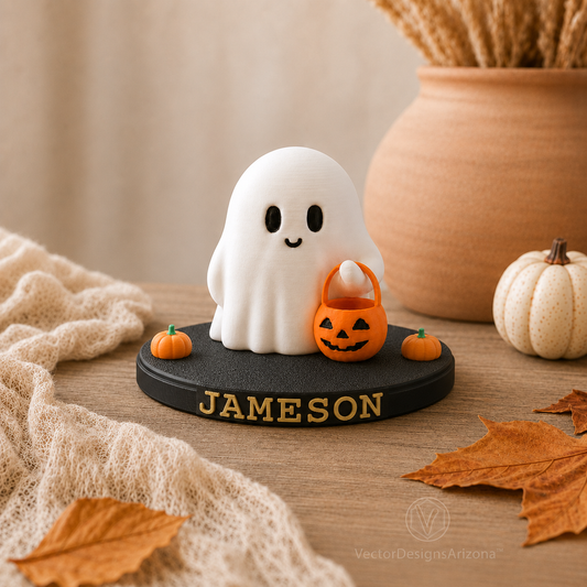White Trick-or-Treat Ghost displayed on a black personalized stand with the name Jameson and small orange pumpkins.