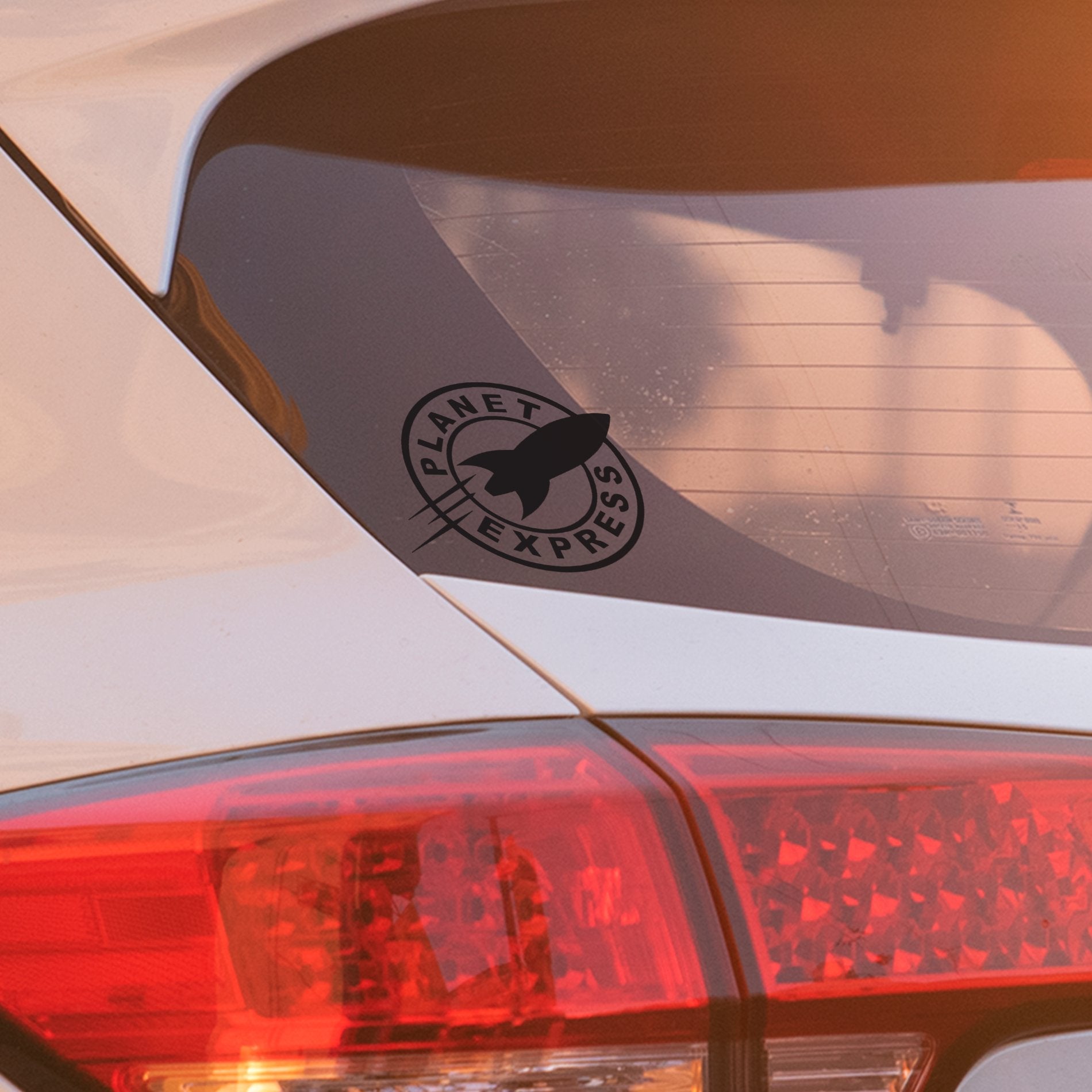 “Planet Express black vinyl decal applied to car window, permanent weather-resistant sticker for vehicles.”