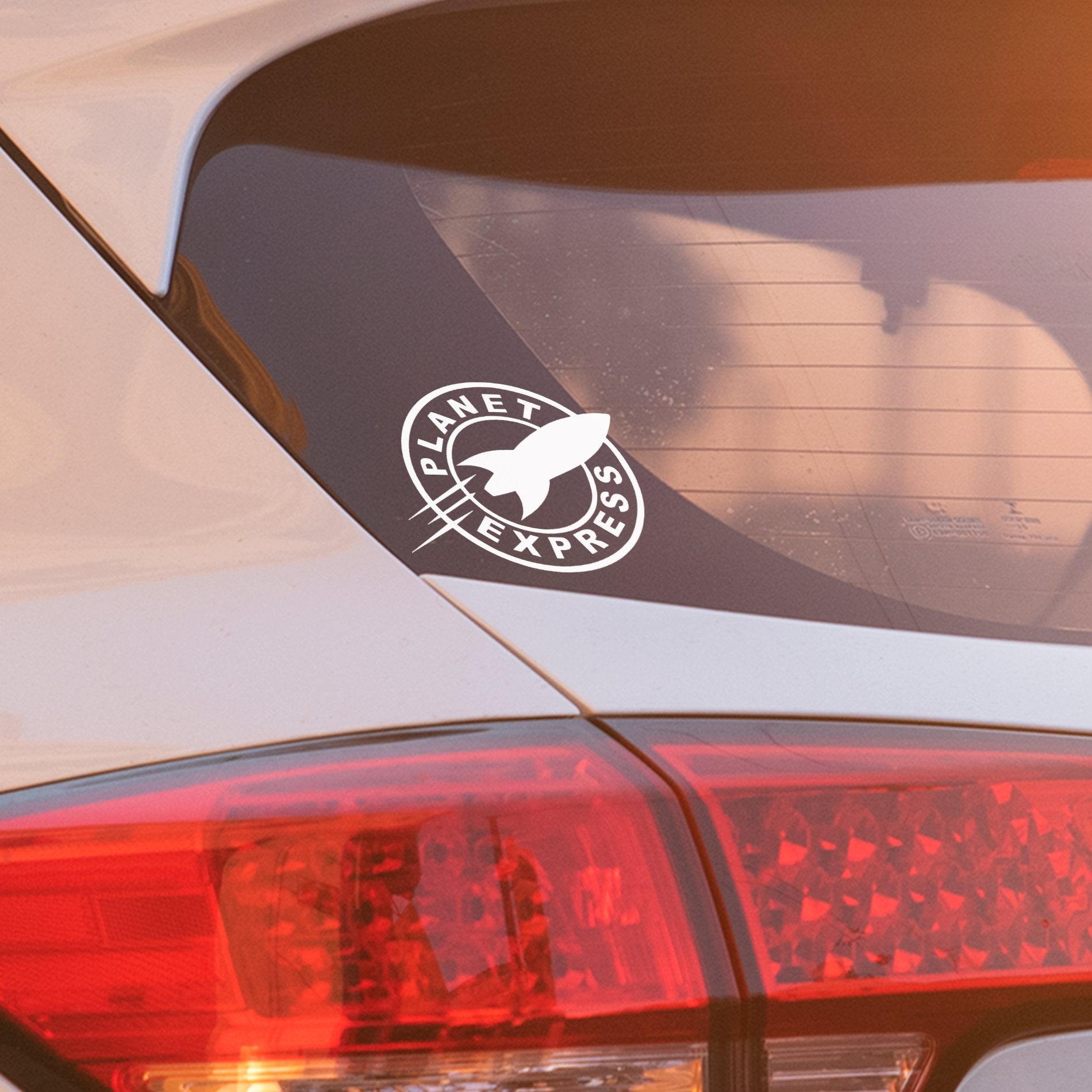 Planet Express white vinyl decal applied to car window, weatherproof permanent sticker for vehicle décor.