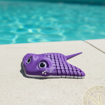 Deep purple 3D printed articulated stingray toy sitting on a pool deck with blue water in the background.