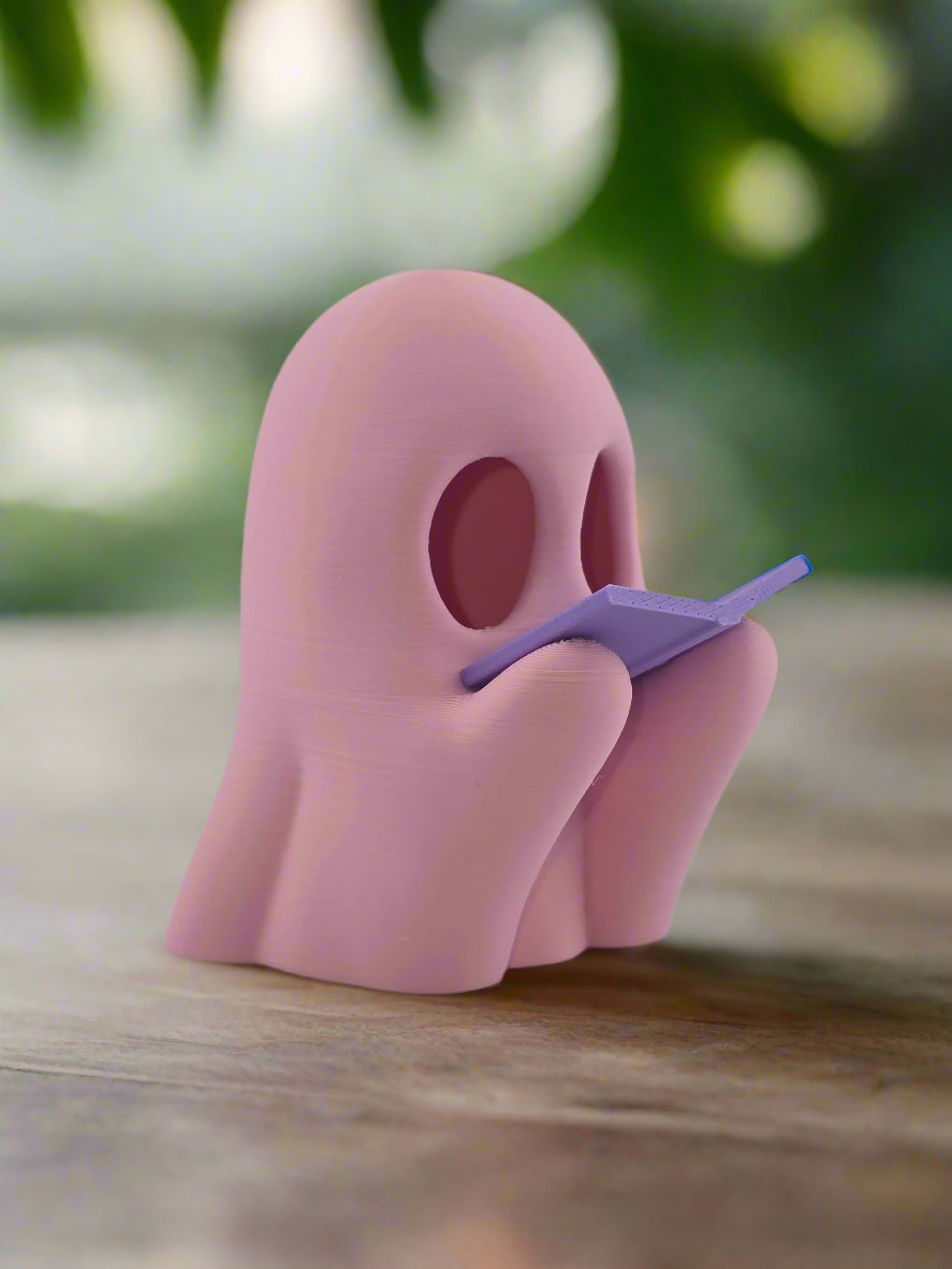 Reading Ghost candle glowing at night on nightstand