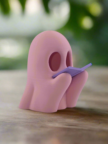 Reading Ghost candle glowing at night on nightstand