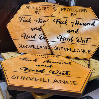 VectorDesignsArizona Laser-etched birch wood sign with bold funny ‘Protected by Surveillance’ warning message, 12x12 inch plaque coated for indoor and outdoor use by Vector Designs Arizona 