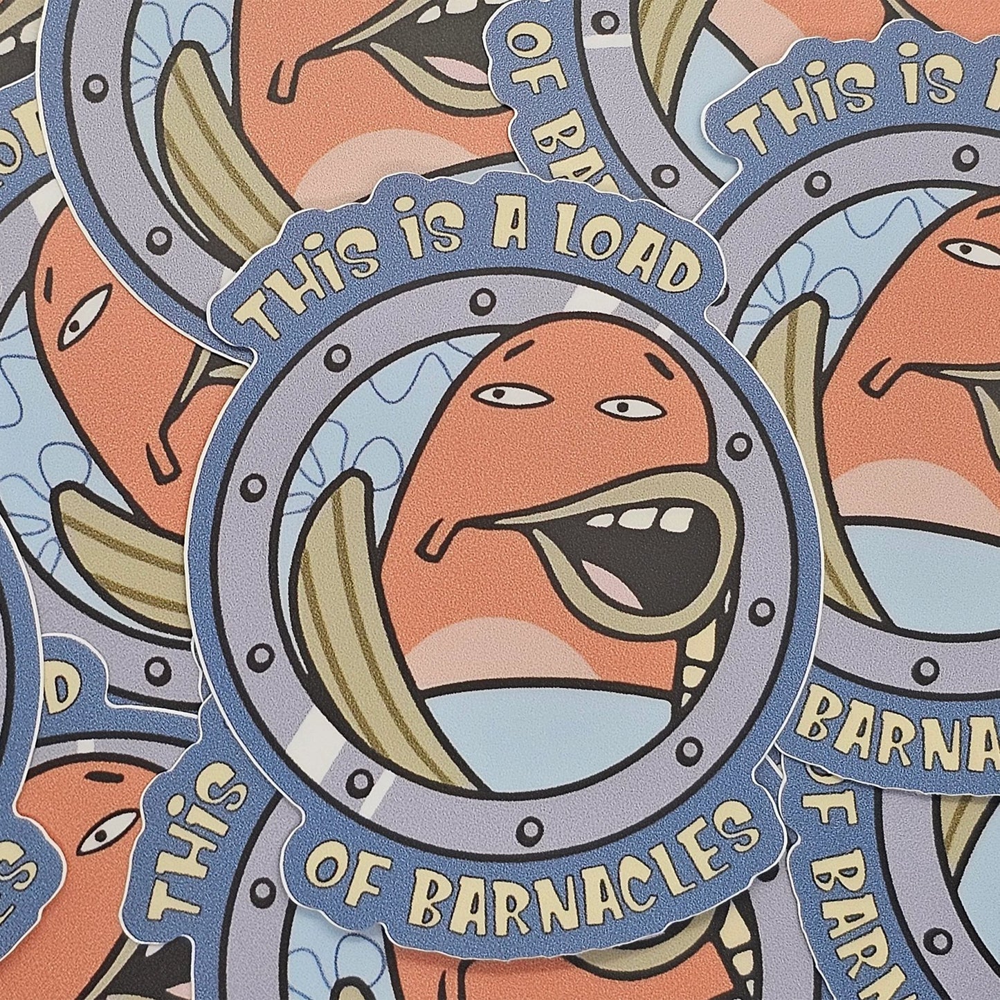 Pile of overlapping barnacles cartoon vinyl stickers showing full colorful porthole design.