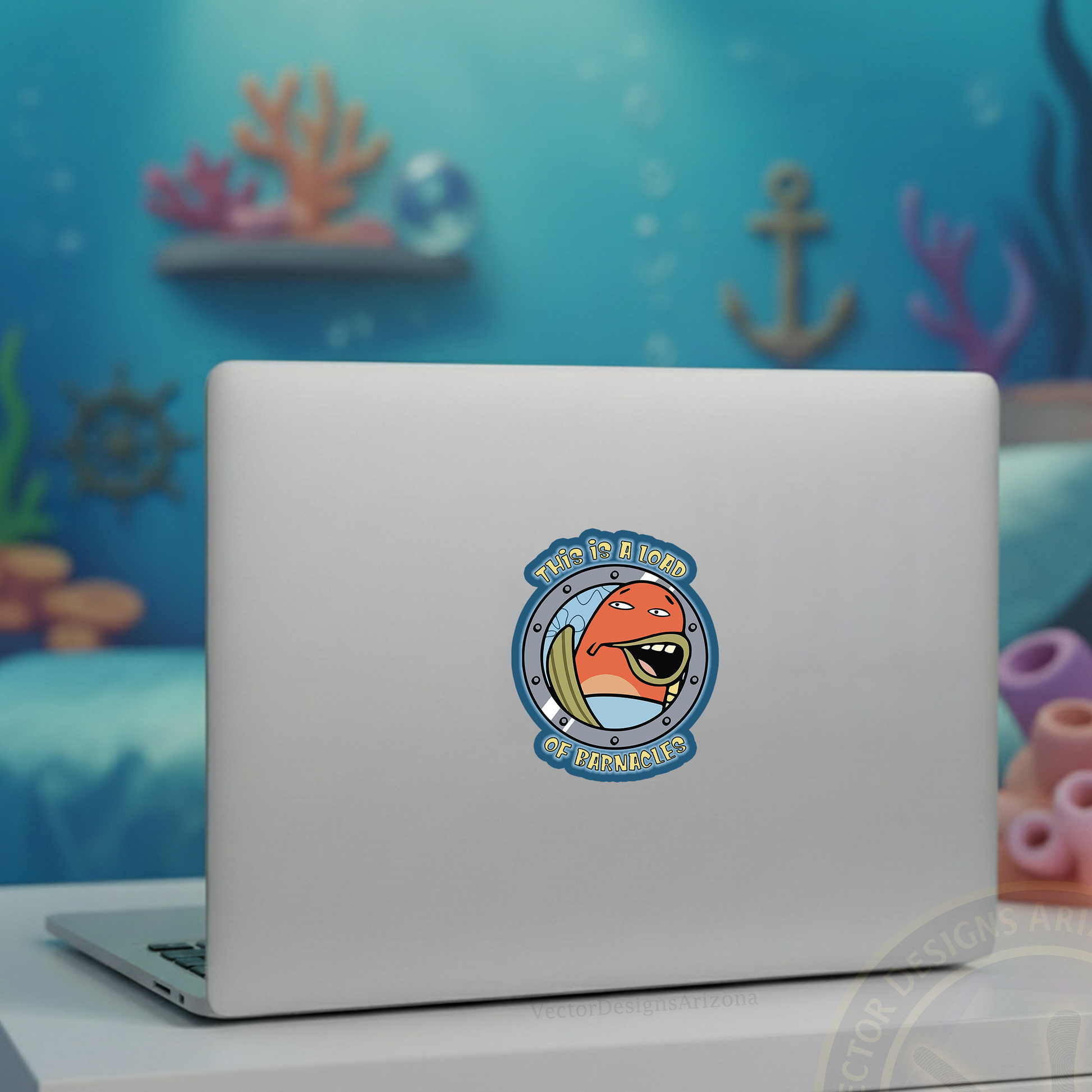 Cartoon barnacles vinyl sticker on center of silver laptop, with soft-focus ocean-themed backdrop.