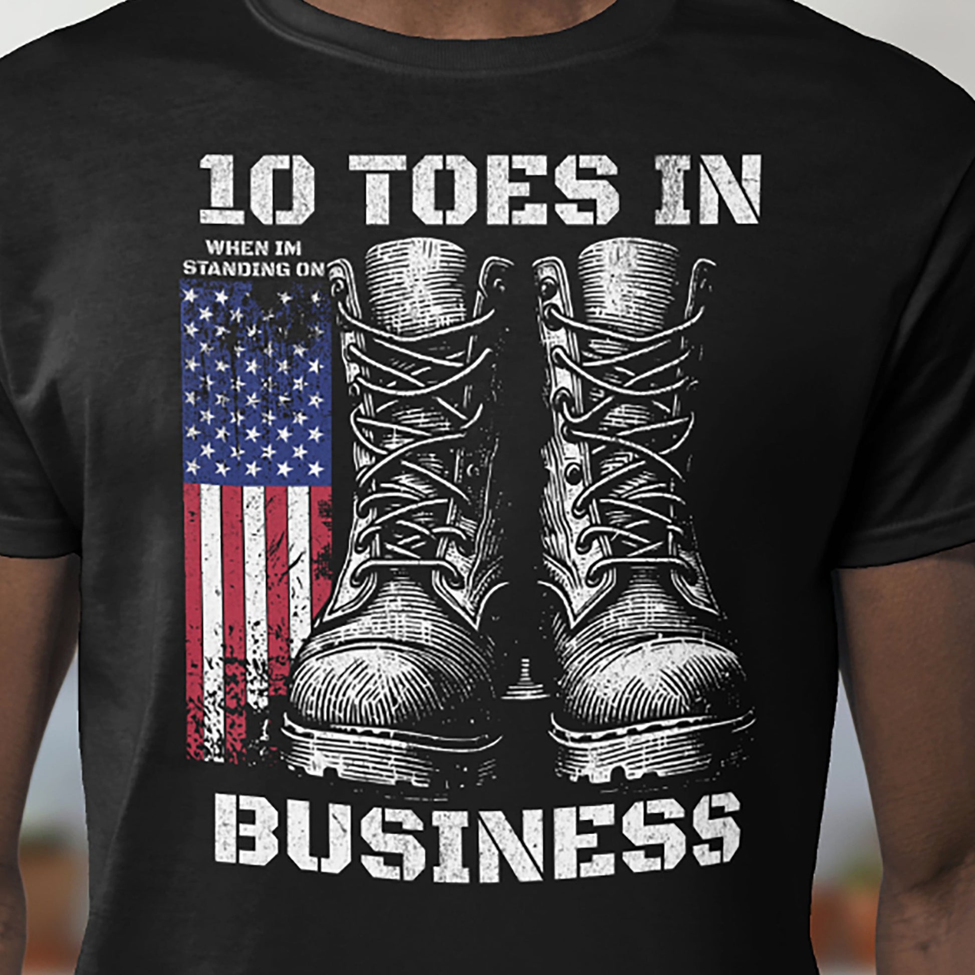 Black patriotic T-shirt with combat boots and American flag graphic on chest.