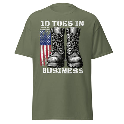 Military green patriotic T-shirt with boots and American flag graphic on white background.