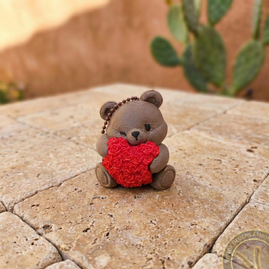 Front view of a brown 3D printed bear zipper pull holding a red rose heart, an artisanal Valentine gift from Arizona.