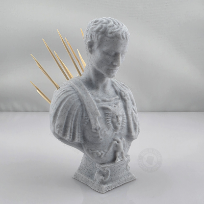 Angled side view of speckled marble Caesar bust toothpick holder showing detailed armor and wooden toothpicks in the back