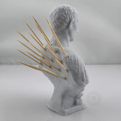 Back angle of 3D printed marble style Caesar bust toothpick holder with wooden toothpicks fanned across the back on a white studio background