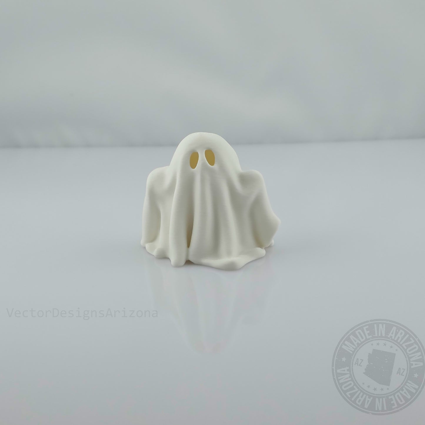 Single minimalist white ghost figurine on glossy white background, front view.