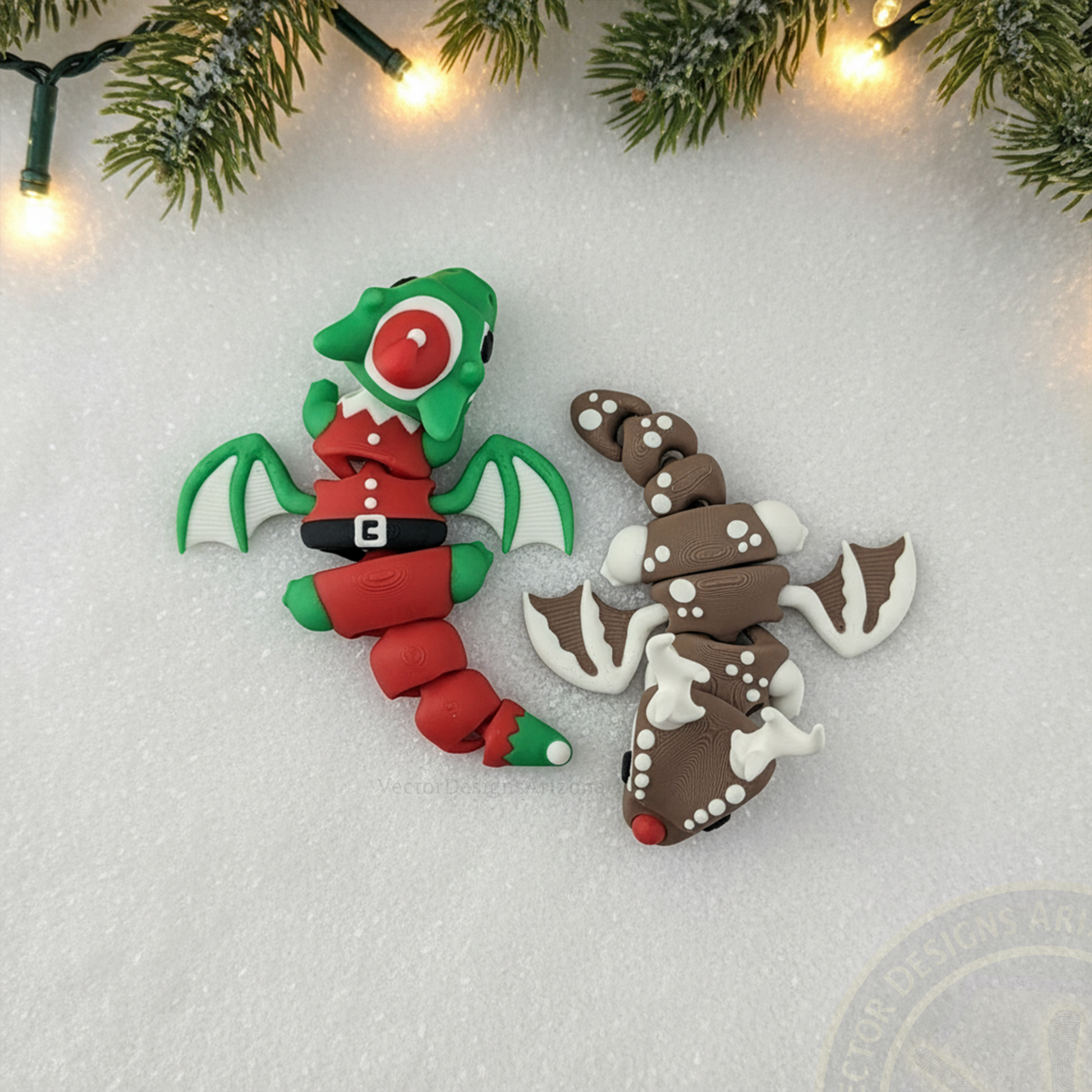 Top view of VectorDesignsArizona 3D printed flexi Elf Dragon and Reindeer Christmas figurines on snow with pine branches and warm lights.