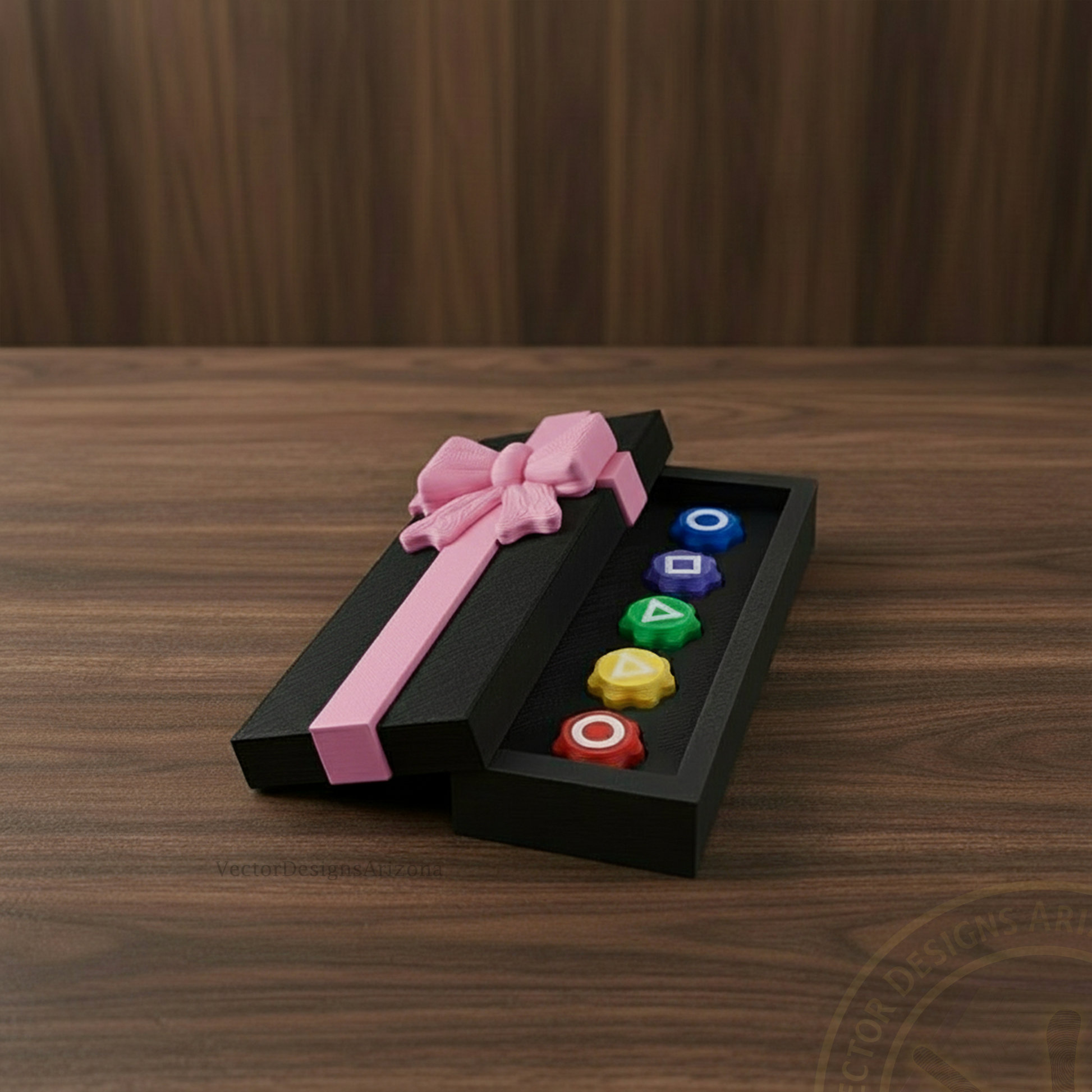 VectorDesignsArizona 3D printed gonggi game gift box with pink ribbon, open on a walnut table showing colorful gonggi pieces