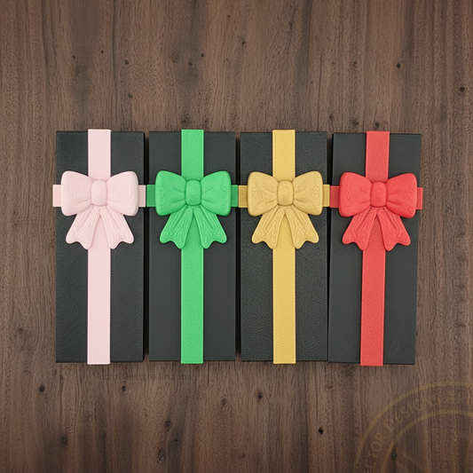Top view of VectorDesignsArizona 3D printed gonggi game gift boxes with pink, green, gold and red ribbons on walnut wood.