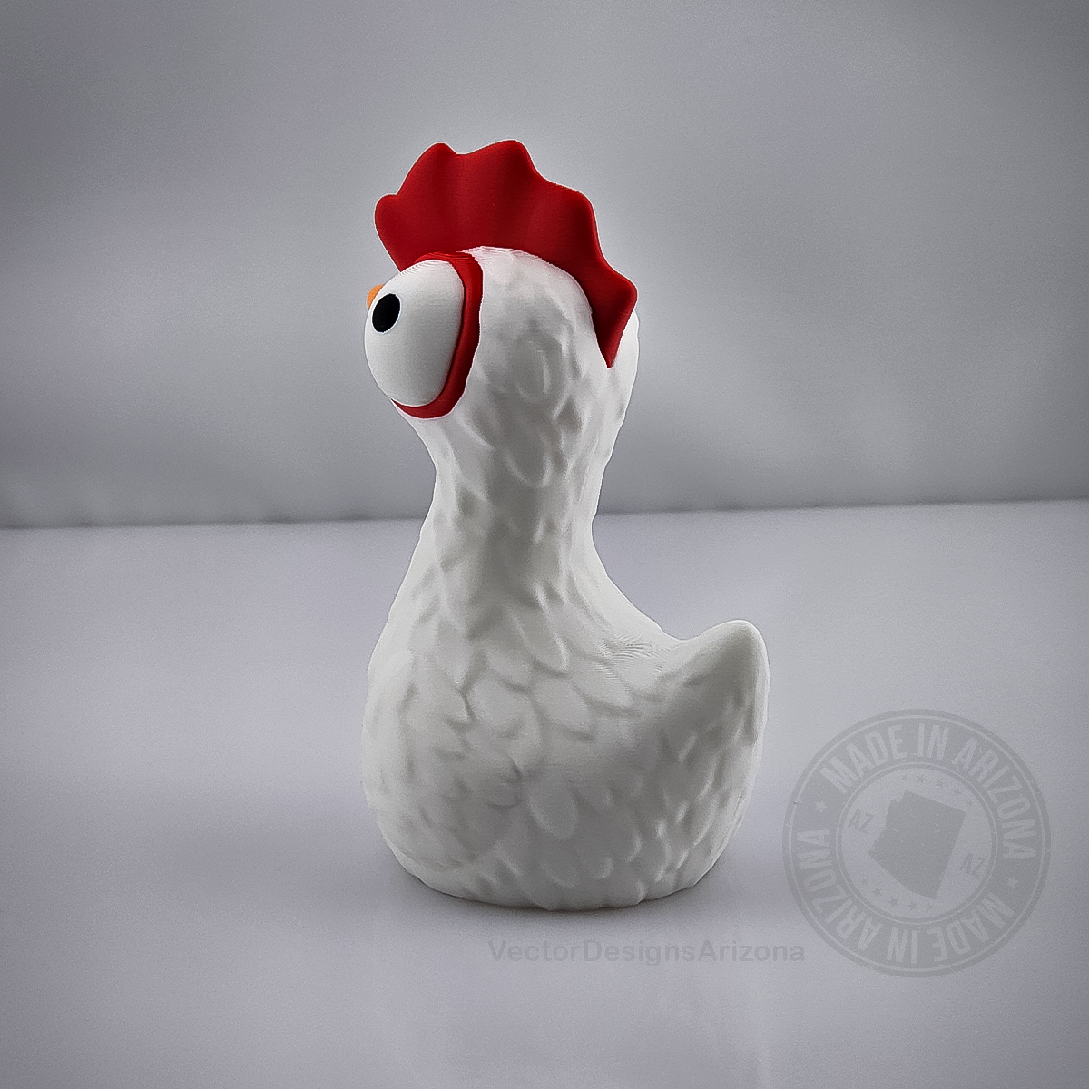 Back view of goofy chicken figurine with red comb on light grey background.