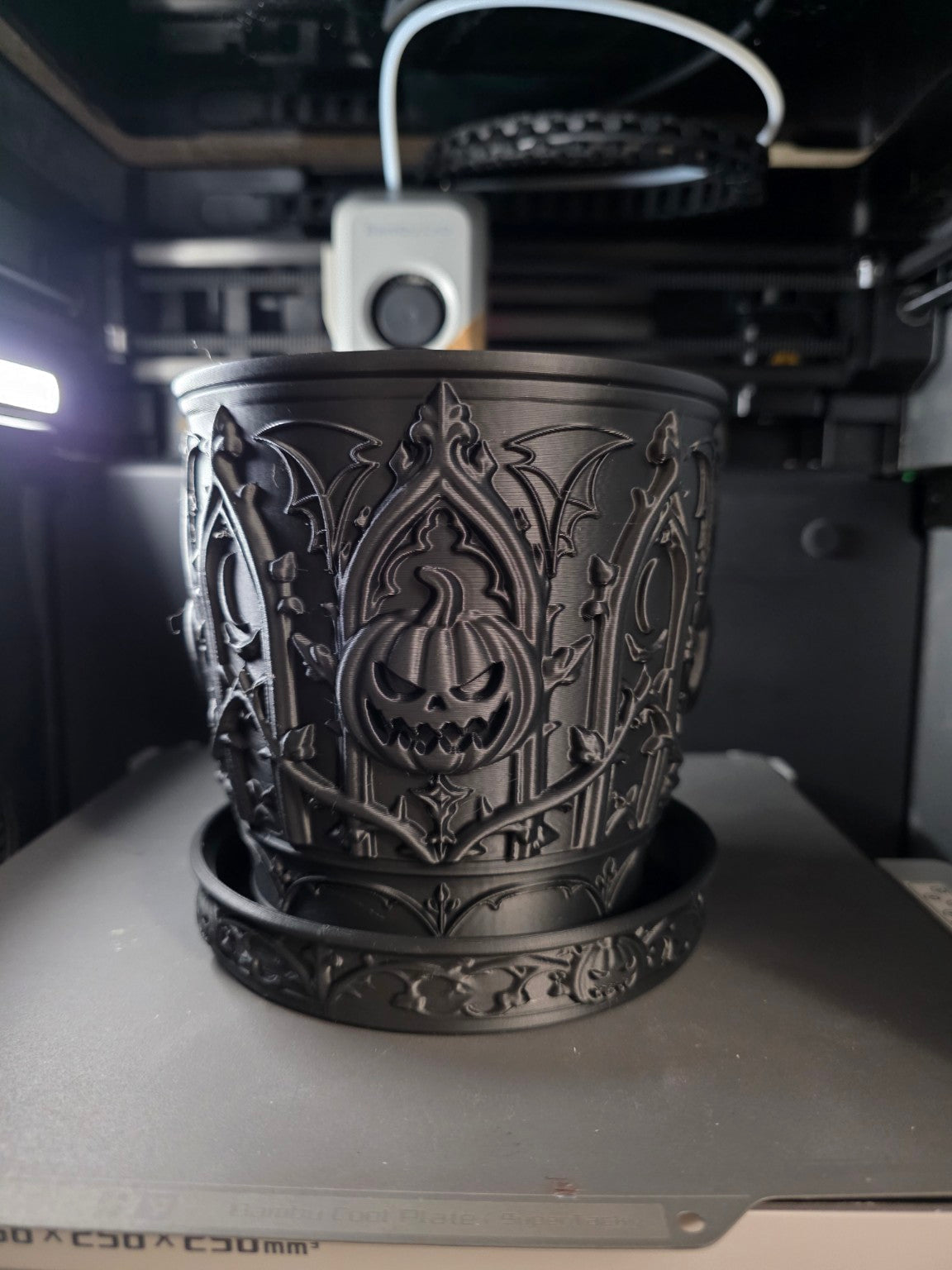 Actual matte black gothic pumpkin dry planter with matching saucer, front view