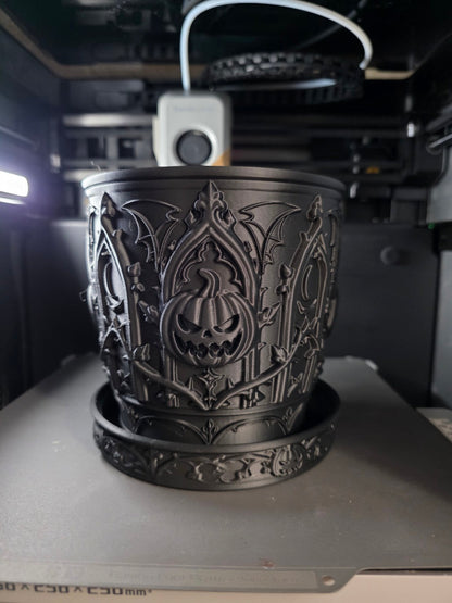 Actual matte black gothic pumpkin dry planter with matching saucer, front view