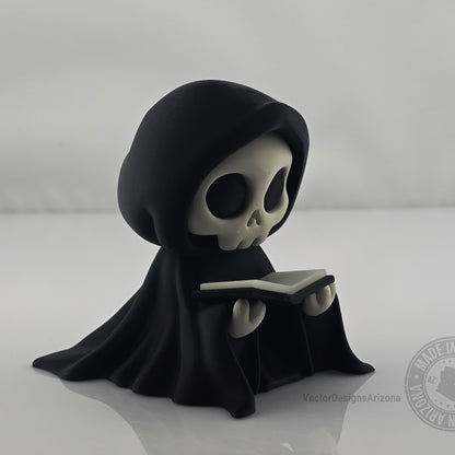 Cute grim reaper figurine holding black-edged book on clean white background.