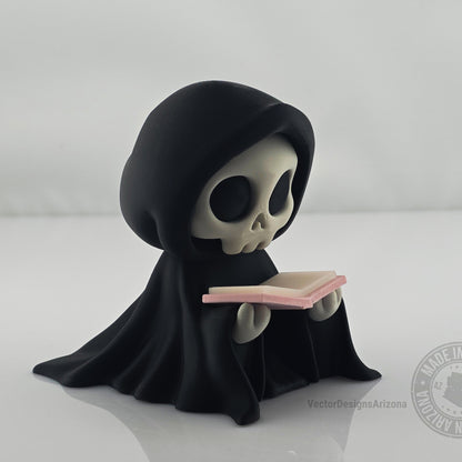 Cute grim reaper figurine holding pastel pink book on white background.